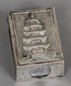 A Chinese silver matchbox holder, maker's mark of KMS
Decorated in relief with a pagoda; together