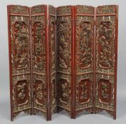 A late 19th/early 20th century Chinese carved hardwood four fold screen
Carved with gilt