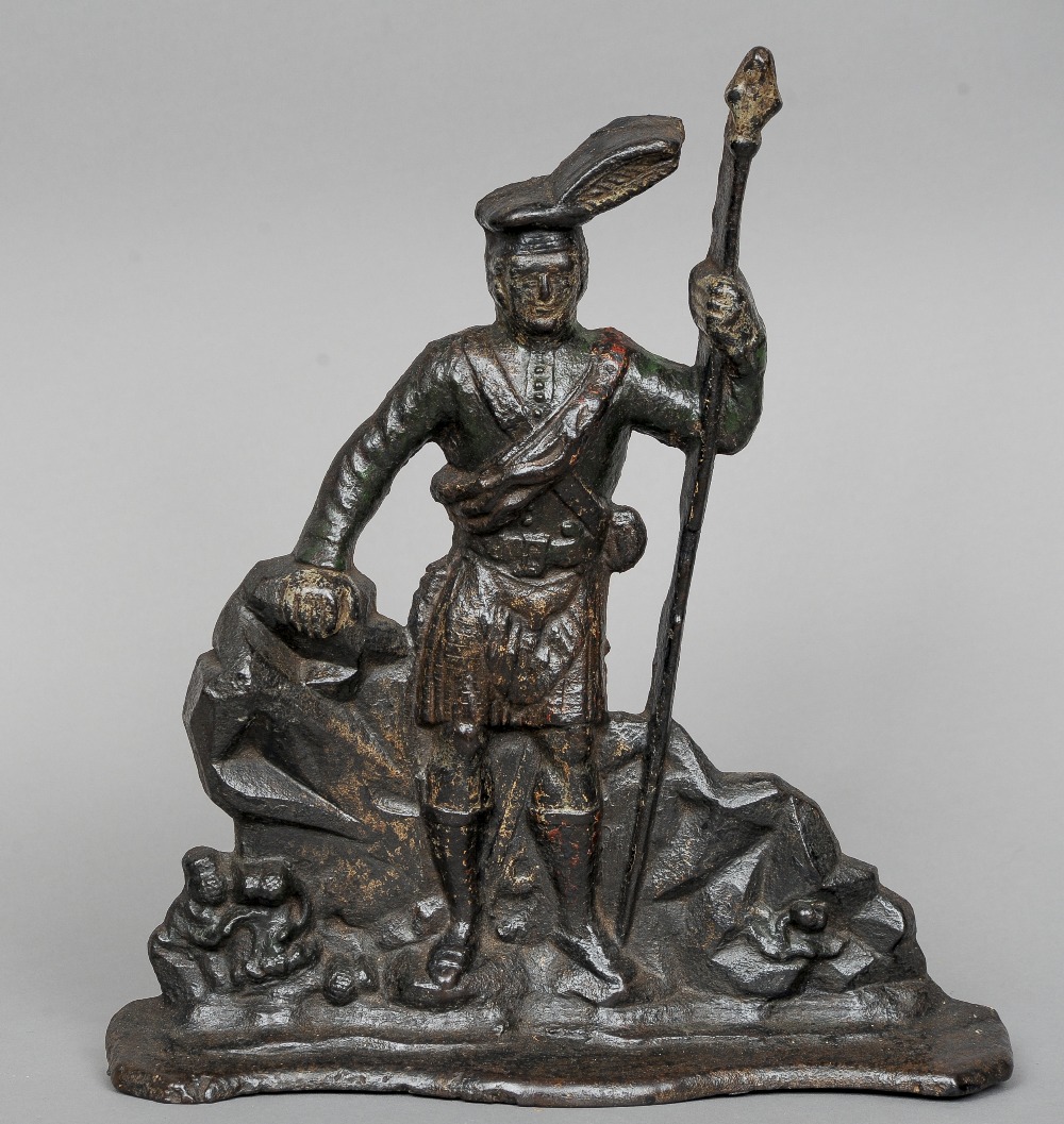 A 19th century cast iron doorstop
Formed as a Scottish Highlander, in traditional attire.  38 cm