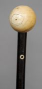 A 19th century ivory  mounted walking stick
The ball finial above the plain stick with a