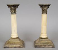 A pair of late 19th century silver plate mounted ivory columnar candlesticks
The central ivory