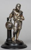 A late 19th/early 20th century silvered figure of a Negro
Modelled leaning against a post,