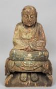 A large carved wooden model of Buddha
Typically modelled seated in the lotus position with traces of