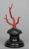 A small red coral specimen
Mounted on an ebonoised wooden display stand.  14.5 cm high. CONDITION
