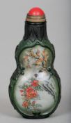 A Peking glass inside decorated snuff bottle
Of double gourd form with painted and carved