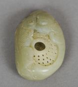 A miniature Chinese carved jade brush washer
Of pierced pebble form decorated with a fish, the brush