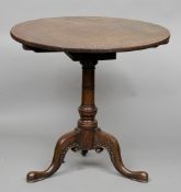 A Georgian mahogany tilt-top tripod table
The circular top above the turned column, standing on