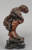 An 18th century Oriental root wood figural carving
Modelled as a laughing bearded man, standing on