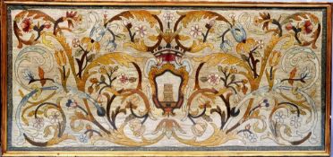 A 16th century Italian tapestry panel
With scrolling floral decoration centred with a crest,