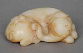 A Chinese carved jade type elephant
In recumbent pose.  8 cm long. CONDITION REPORTS: Generally in
