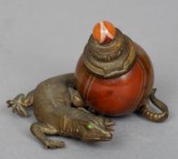 A patinated bronze and agate inkwell
Formed as a lizard, his tail encompassing the agate well.  8 cm