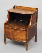 A 19th century mahogany bedside commode
Of bow front form, the upper tier above a recess and twin