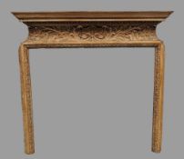 A 19th century carved oak fireplace, in the manner of William Kent
The stepped moulded mantel