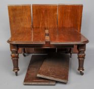 A large Victorian mahogany extending dining table
The moulded rounded rectangular top