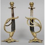 A pair of 19th century naval sword handle candlesticks
Each standing on a pierced spreading base.