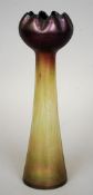 A tall iridescent Art glass vase
Of thistle form, with purple and green hues.  34 cm high. CONDITION