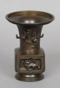 A late 19th century Chinese patinated bronze vase
Decorated in relief with panels of mythical