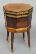 An early 19th century brass bound mahogany cellaret on stand
Of octagonal form with hoop handles,