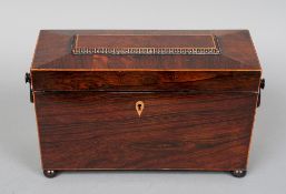 A William IV rosewood tea caddy of typical form with ring handles, fitted interior and flattened bun