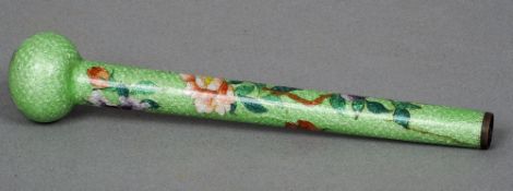 A Chinese enamel decorated parasol handle
The green ground with floral and butterfly decoration.