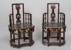 A pair of Chinese carved hardwood open armchairs
Each with a shaped pierced back splat and curved