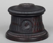 A 19th century Continental carved hardwood box
Of cylindrical form, the gadrooned domed lid carved