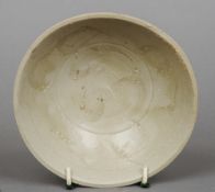 A Ming Dynasty celadon glazed dish
The interior with incised decoration.  15.5 cm diameter.
