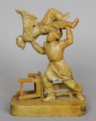 A 19th century Chinese carved soapstone figural group
Formed as two figures fighting, the front of