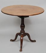 A George II mahogany bird-cage tilt top table
The circular top above the bird-cage action,