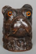 A late 19th century Black Forest carved wooden inkwell
Formed as a dogs head, the hinged lid with