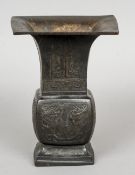 A Chinese bronze gu vase
Typically worked with lappets and stylised dragon masks.  22 cms high.