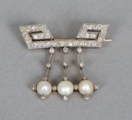 An unmarked gold, diamond and pearl brooch
The main bar of Greek key design issuing three diamond