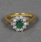 An 18 ct gold emerald and diamond ring