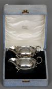 A pair of George III style silver sauceboats, hallmarked Birmingham 1936, maker's mark of