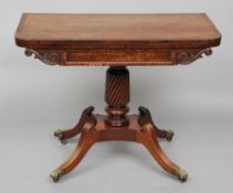 An early 19th century mahogany fold over tea table
The swivelling hinged crossbanded rounded