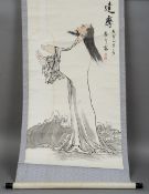 A Chinese scroll painting
Depicting a godly figure amongst clouds and with calligraphy and red