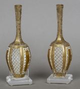 A pair of small 19th century Bohemian white cased gilt decorated glass vases
Each of rounded