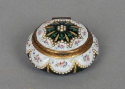 A 19th century enamel decorated pill box
Of lobed circular form inset with small cabochon roundels.