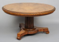 A Regency pollard oak breakfast table
The lappet carved circular top standing on a fluted column