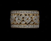 A 9 ct gold diamond set ring
Of pierced banded form, centred with numerous small diamonds. CONDITION