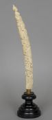 A Lyangwa carved ivory tusk ornament
Decorated in the round with tribal figures, mounted on a