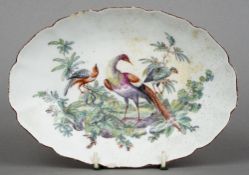 An 18th century Chelsea porcelain dish
Decorated with exotic birds within a shaped rim, red