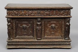 A 17th century and later carved oak coffer
The rectangular hinged lid above a putto carved frieze