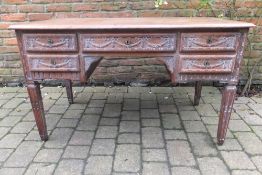 A late 19th century limed oak desk
The moulded rectangular top above five carved drawers with five