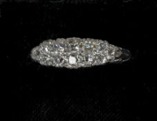 An Edwardian unmarked 18 ct white gold diamond set ring
Of navette form
2 cm wide. CONDITION