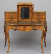 A 19th century walnut bonheur-du-jour
The upper section with central mirrored door flanked with