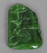 A carved spinach green jade pendant
With carved organic decoration.  7 cm high. CONDITION REPORTS: