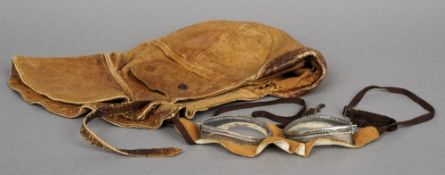 A pair of vintage flying goggles
Together with a leather flying helmet.  (2) CONDITION REPORTS: