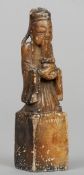 A Chinese carved soapstone seal
Surmounted with the figure of a scholar.  10 cms high. CONDITION