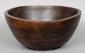 A large 19th century turned elm bowl
The exterior with incised banded decoration.  40 cm wide.